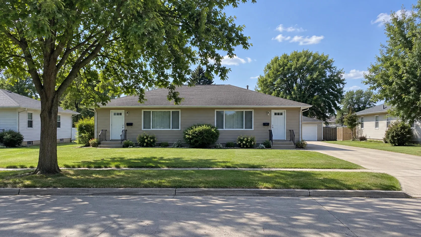 A well-kept rental property on a summer street in the Iowa Great Lakes