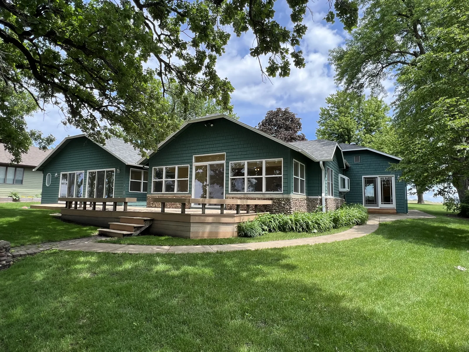 Well-kept lakefront cottage with a broad deck and lawn on Lake Okoboji, Iowa