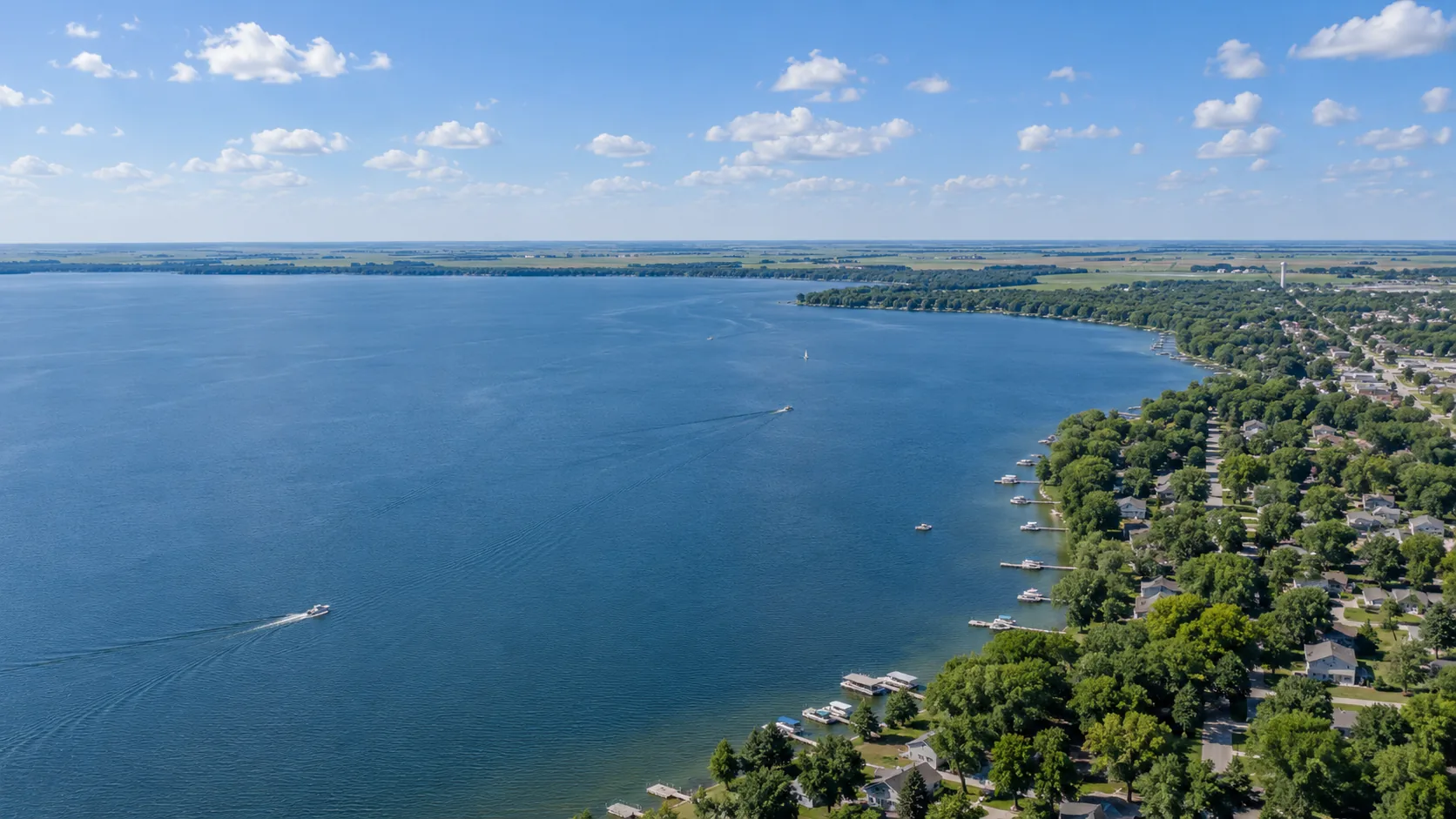 An aerial view across Big Spirit Lake at Spirit Lake, Iowa on a bright day with scattered cloud
